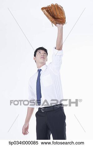 Stock Photography - A man holding up a baseball glove. Fotosearch
