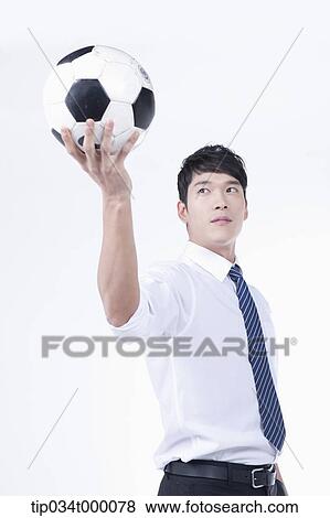 A man holding up a soccer ball View Large Photo Image Stock Photo - A man holding up a soccer ball. Fotosearch
