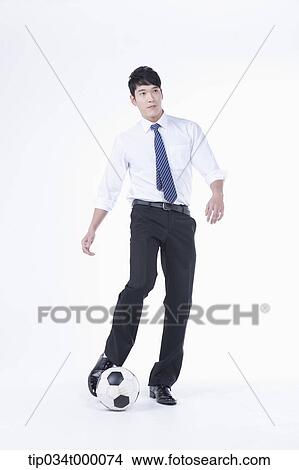 A man kicking a soccer ball View Large Photo Image Picture - A man kicking a soccer ball. Fotosearch