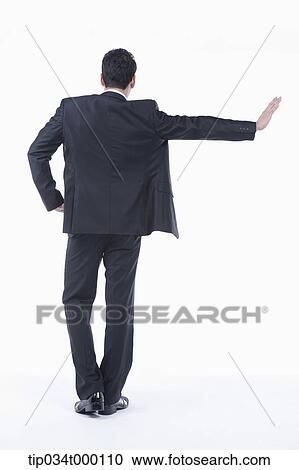 Stock Image - A man leaning on the wall with his hand. Fotosearch