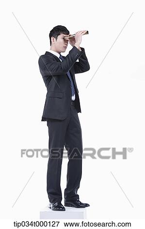 Stock Photo - A man looking through the telescope. Fotosearch