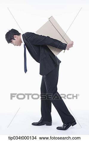Picture - A man moving the box . Fotosearch