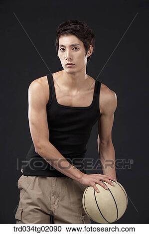 Stock Image - A man playing basketball. Fotosearch