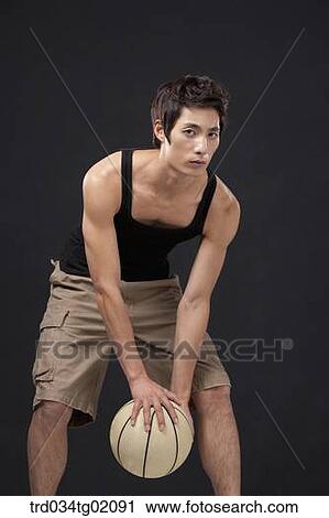 A man playing basketball View Large Photo Image Stock Image - A man playing basketball. Fotosearch