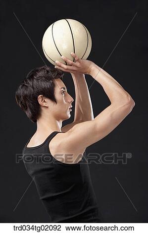 Stock Image - A man playing basketball. Fotosearch