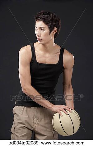 Stock Photo - A man playing basketball. Fotosearch