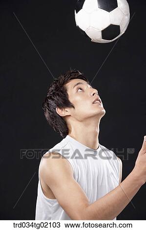 Stock Image - A man playing soccer. Fotosearch