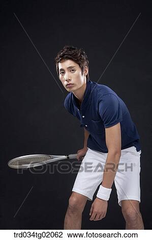 Stock Image - A man playing tennis. Fotosearch