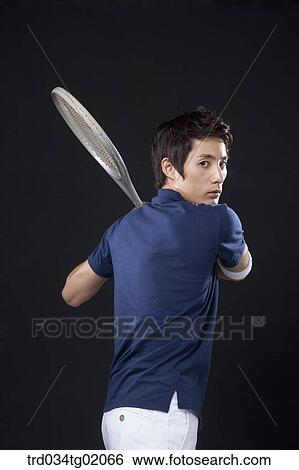 Stock Photograph - A man playing tennis. Fotosearch