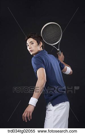 Stock Photography - A man playing tennis. Fotosearch