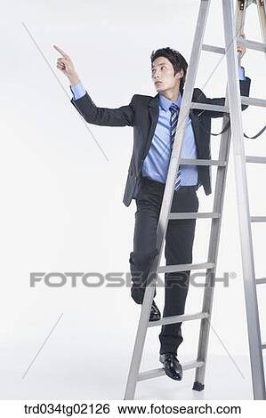 Stock Photograph - A man pointing his finger on the ladder. Fotosearch