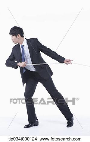 Picture - A man pulling a rope. Fotosearch
