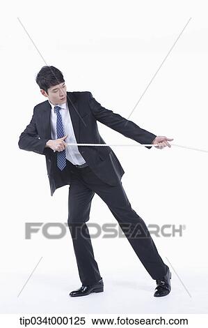 Stock Photography - A man pulling a rope. Fotosearch