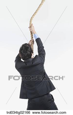 A man pulling the rope View Large Photo Image Stock Photograph - A man pulling the rope . Fotosearch