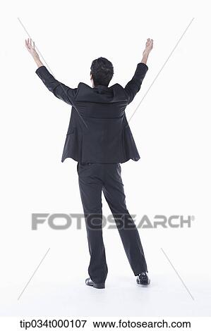Stock Photo - A man putting his arms up to the sky. Fotosearch