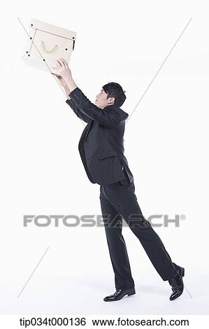 Stock Photograph - A man putting on the box. Fotosearch