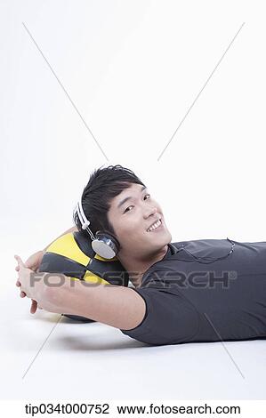 A man resting on the basketball with the headset on View Large Photo Image Stock Image - A man resting on the basketball with the headset on . Fotosearch
