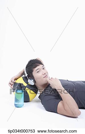 A man resting on the basketball with the headset on View Large Photo Image Stock Image - A man resting on the basketball with the headset on . Fotosearch