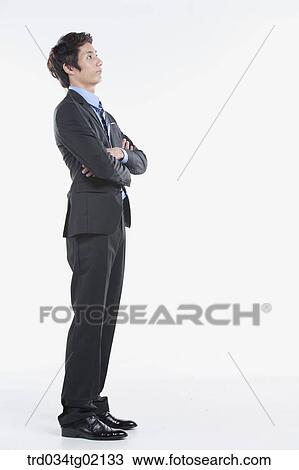 A man standing with his arms crossed View Large Photo Image Stock Image - A man standing with his arms crossed. Fotosearch