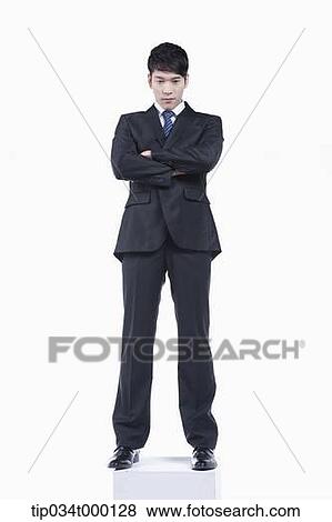 Stock Photo - A man standing with his arms crossed. Fotosearch
