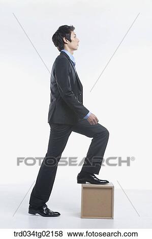A man stepping on the box View Large Photo Image Stock Photo - A man stepping on the box . Fotosearch
