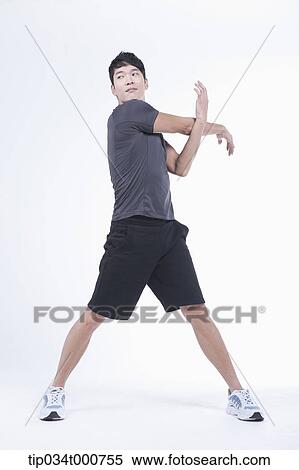 Stock Photography - A man stretching his arms. Fotosearch