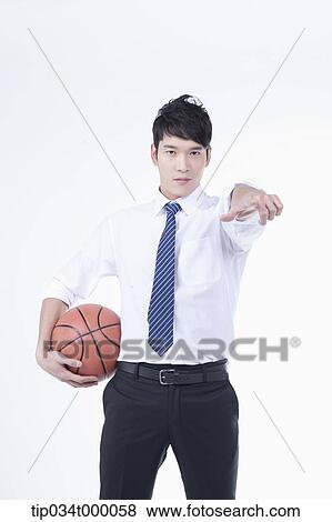 Stock Photo - A man stretching his hand with a basketball. Fotosearch