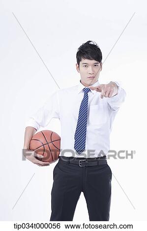 Stock Photograph - A man stretching his hand with a basketball. Fotosearch