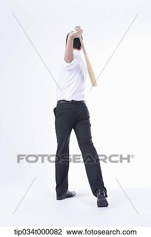 A man swinging a bat View Large Photo Image Stock Image - A man swinging a bat. Fotosearch