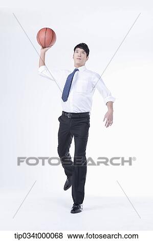 Stock Photo - A man throwing a basketball. Fotosearch