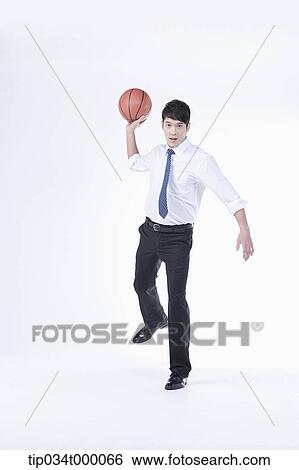 Stock Photograph - A man throwing a basketball. Fotosearch