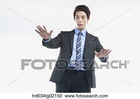 Stock Image - A man touching something with his palm . Fotosearch