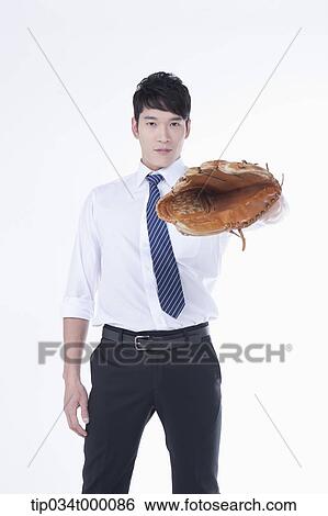 A man wearing a baseball glove View Large Photo Image Stock Photograph - A man wearing a baseball glove. Fotosearch