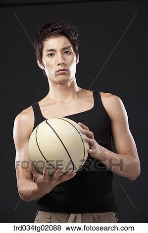 Stock Photo - A man with a basketball. Fotosearch