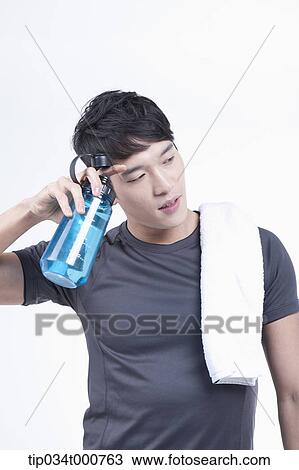 Stock Image - A man with a bottle of water and a towel. Fotosearch