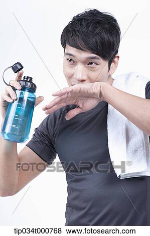 A man with a bottle of water and a towel View Large Photo Image Stock Photo - A man with a bottle of water and a towel. Fotosearch