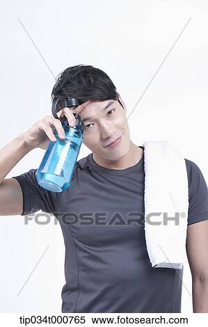 A man with a bottle of water and a towel View Large Photo Image Stock Photography - A man with a bottle of water and a towel. Fotosearch