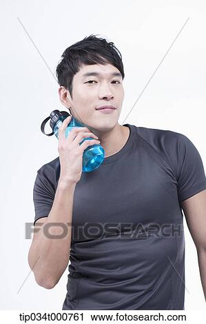 Stock Image - A man with a bottle of water. Fotosearch
