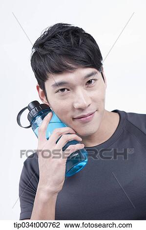 Stock Image - A man with a bottle of water. Fotosearch