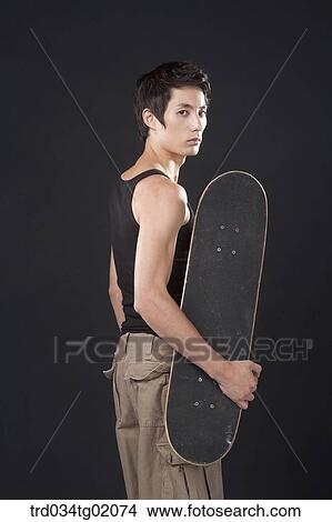 Picture - A man with a skateboard. Fotosearch