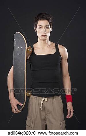 A man with a skateboard View Large Photo Image Stock Image - A man with a skateboard. Fotosearch
