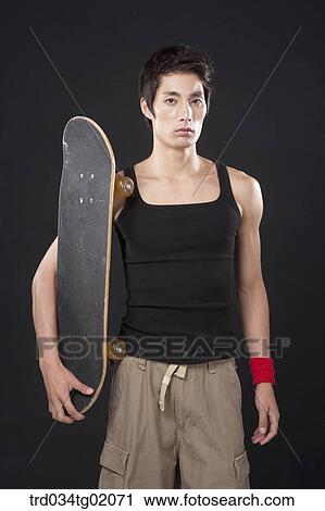 A man with a skateboard View Large Photo Image Stock Image - A man with a skateboard. Fotosearch