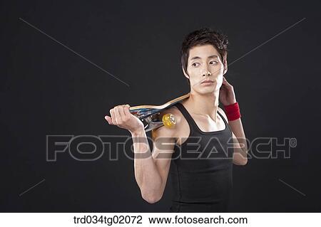 A man with a skateboard View Large Photo Image Stock Image - A man with a skateboard. Fotosearch