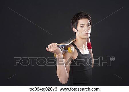 A man with a skateboard View Large Photo Image Stock Image - A man with a skateboard. Fotosearch