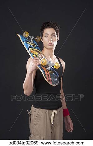A man with a skateboard View Large Photo Image Stock Photo - A man with a skateboard. Fotosearch