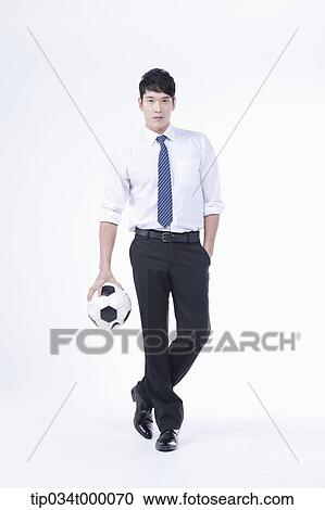 Stock Image - A man with a soccer ball. Fotosearch