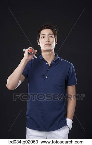 Stock Image - A man with a tennis racket. Fotosearch