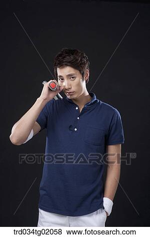 Stock Photo - A man with a tennis racket. Fotosearch