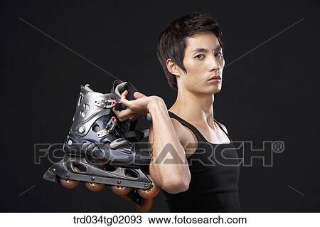 Stock Image - A man with in-line skate. Fotosearch
