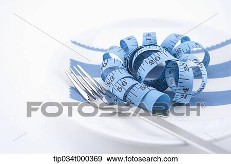 Stock Photo - A measuring tape on the dish. Fotosearch